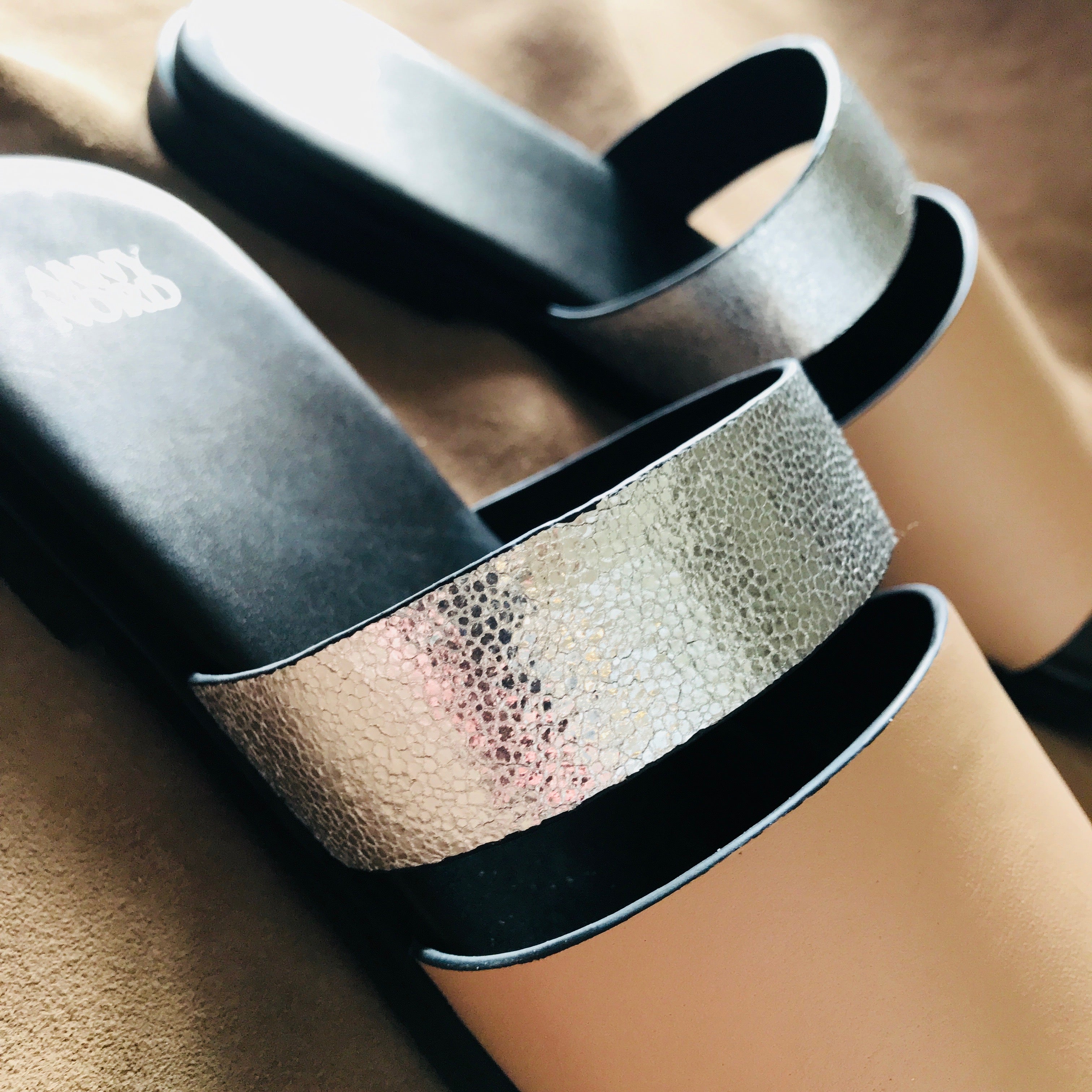 BUSY DOING NOTHING is a comfortable luxury slide sandal in pale nude and silver leather from Swedish shoe and accessory brand ANNY NORD