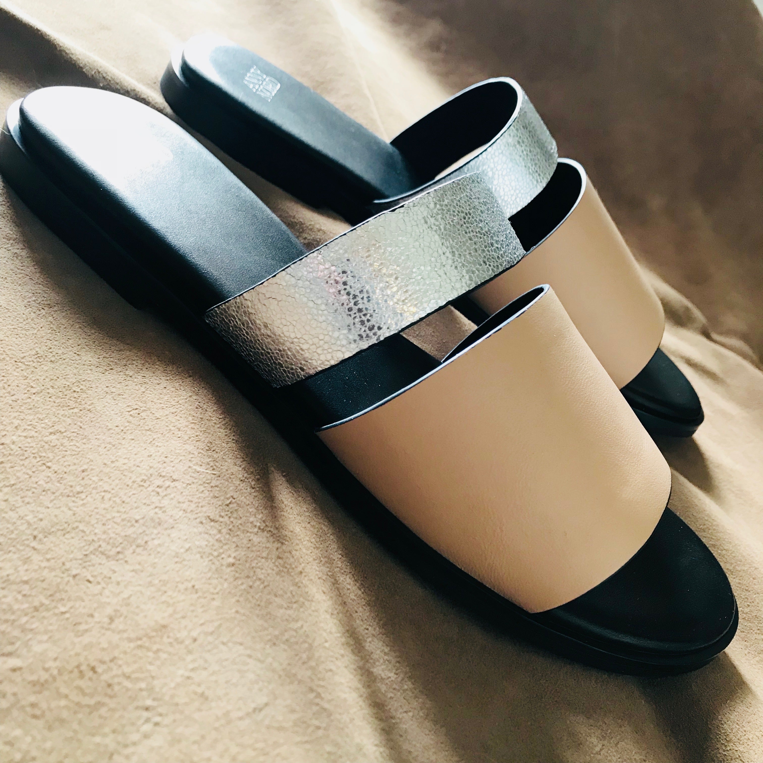 BUSY DOING NOTHING is a comfortable luxury slide sandal in pale nude and silver leather from Swedish shoe and accessory brand ANNY NORD